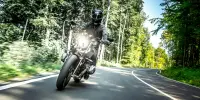 Une moto négocie un virage sur une route